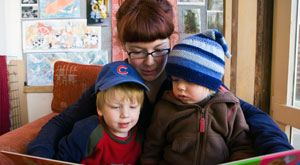 Teacher reading to two young students