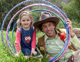 Gril and man on grass with hula hoops