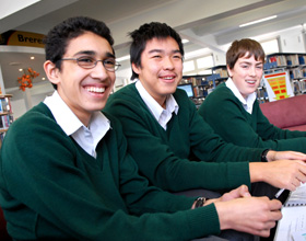 Three school boys sitting in class
