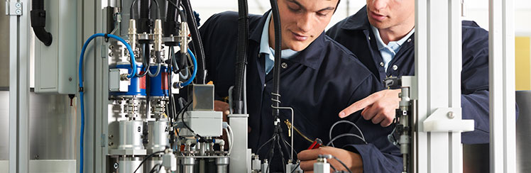 Trainee examining a liquid in a laboratory setting
