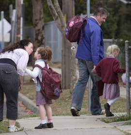 parents saying goodbye to their children at the school gate