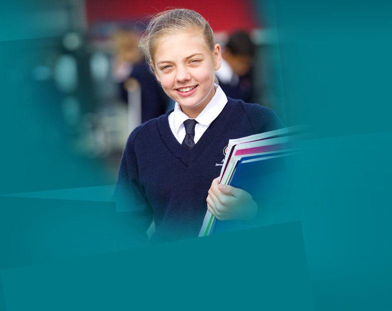 Yound school girl holding books.