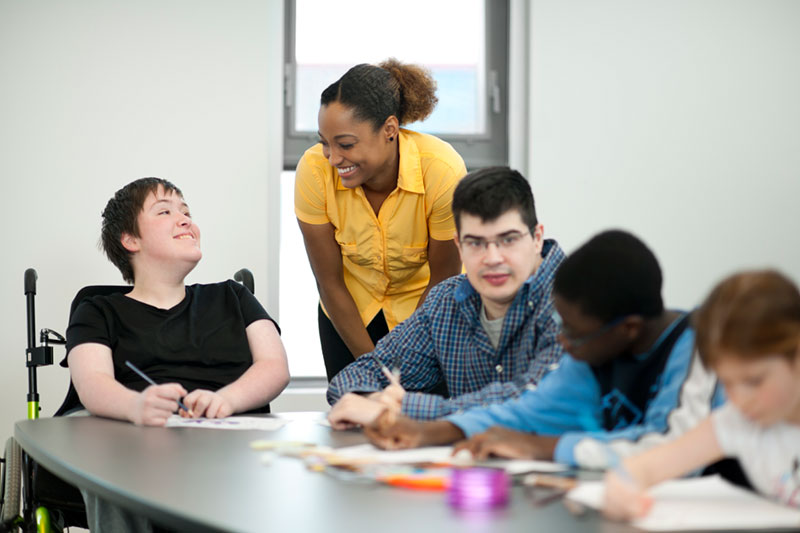 Group of students being helped by a teacher