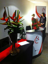 Two women talking at front desk at conference