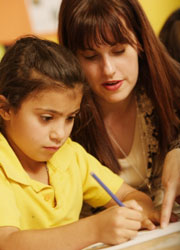 Girl learning with teacher