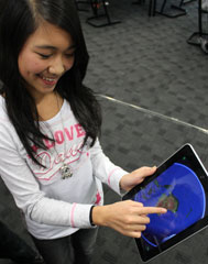 Girl standing using iPad