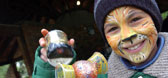 Boy with facepaint holding a toy