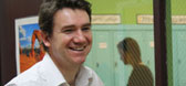 A male teacher laughing