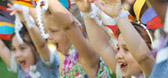 Three students with their arms up in the air