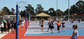 A netball court with a group of teachers playing on it
