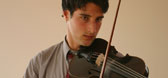 A male student playing the violin