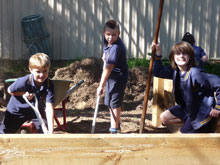 Boys digging in garden