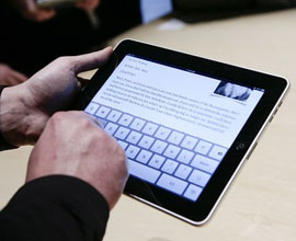 Man's hands holding an iPad.