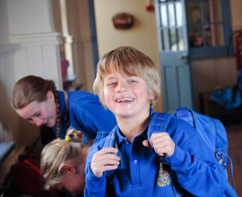 Boy smiling with school bag