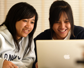 Two girls looking at laptop