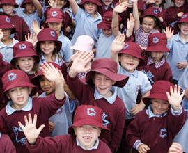 a group of school children waving