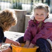 girl playing in a sandpit