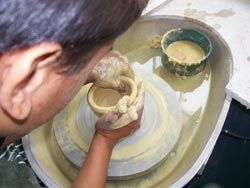 A student learns pottery skills