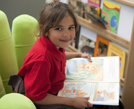 Young student reading picture book