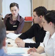 group of adults sitting around table
