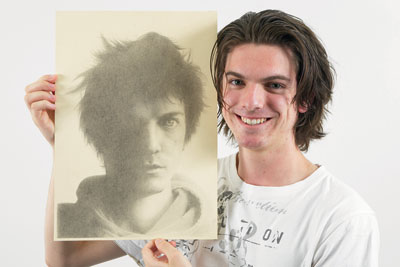 Master artist: Former Kew HS Year 12 student Andrew Fanning with his self-portrait in pencil which will be exhibited in the upcoming Top Arts at the Ian Potter Centre in Federation Square