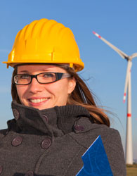 Female engineer standing outside with hard hat on