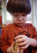 Boy holding stack of coins