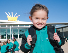 Girl with backpack in playground