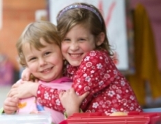two young girls cuddling