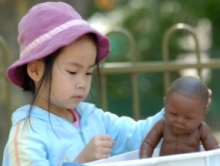 young girl playing with a doll