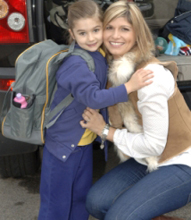 Mother saying goodbye to her daughter at school gate