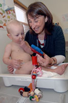 Nurse weighing baby
