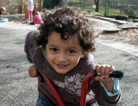 Kindergarten boy riding tricycle
