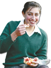 Girl eating fruit salad