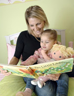 Mother reading book with child