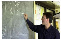teacher working on blackboard