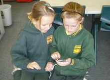 two students using an ipod