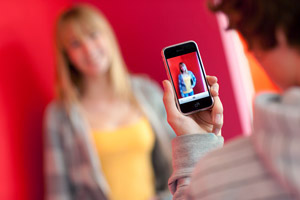 two students working with an iphone