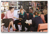 Teacher and students in library