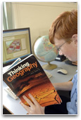 Student reading geography text book