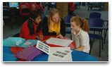Teacher and 2 students in library