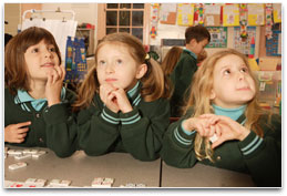 Three school girls in a classroom