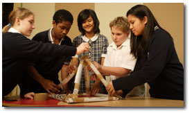 Group of students working on building a pyramid