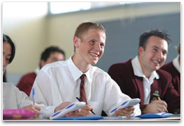 School boys in class using calculators
