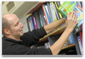 Teacher at a bookshelf