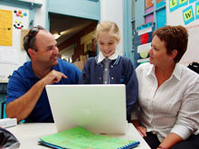 Man, Woman and Child at a Computer
