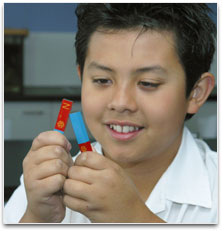 A student pulling apart two bar magnets.