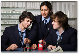 Students with variety of different batteries connected to a digital volt meter