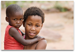 An African child holding a younger child