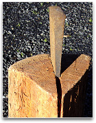 A steel wedge in a wooden log
